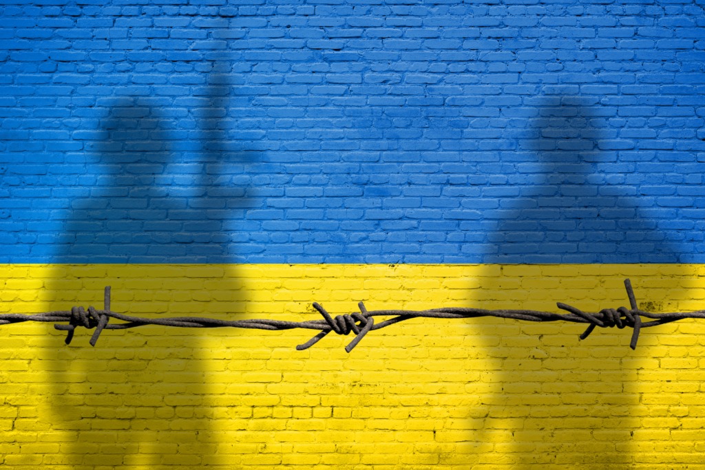 Flag,Of,Ukraine,Painted,On,A,Brick,Wall,With,Soldiers